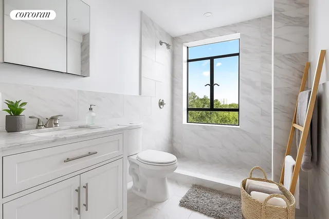 a bathroom with a granite countertop sink toilet and mirror