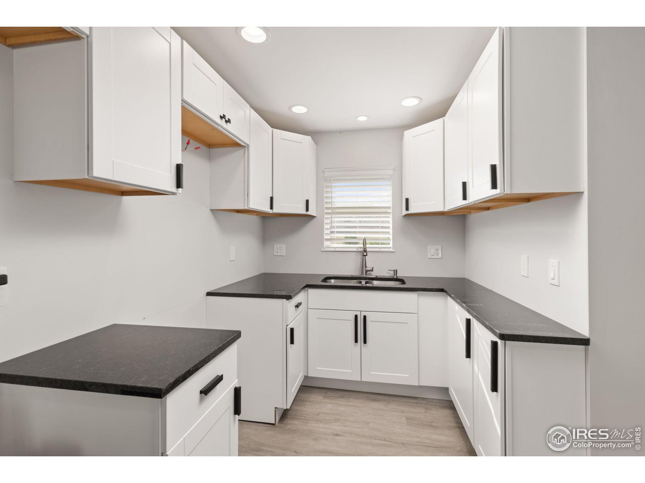 6586 Abaco Lane Berthoud, CO 80513 - Photo 26 of 40 a kitchen with stainless steel appliances granite countertop a sink stove and cabinets