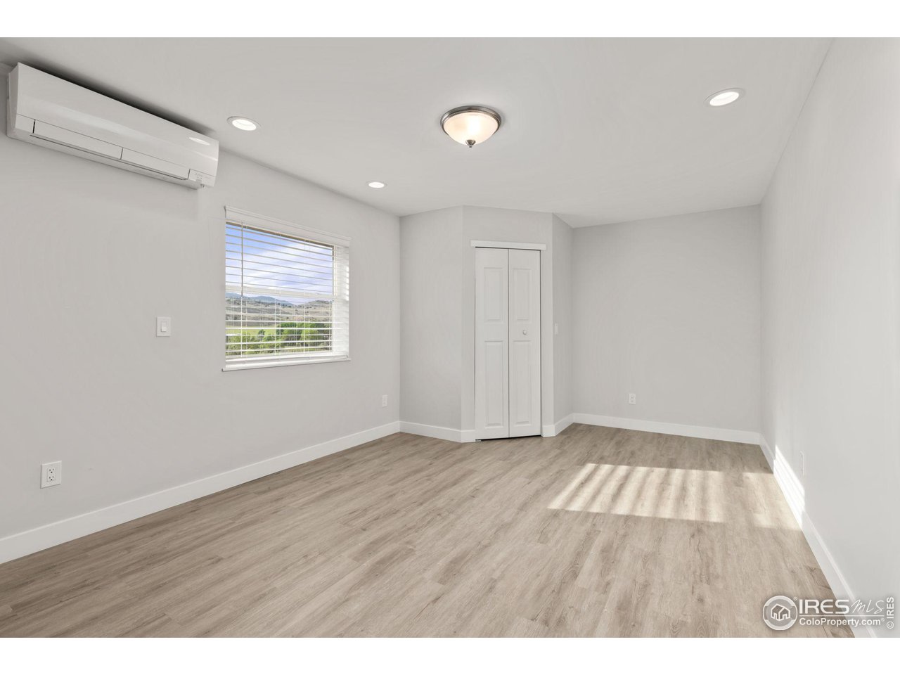 6586 Abaco Lane Berthoud, CO 80513 - Photo 29 of 40 a view of an empty room with wooden floor and a window