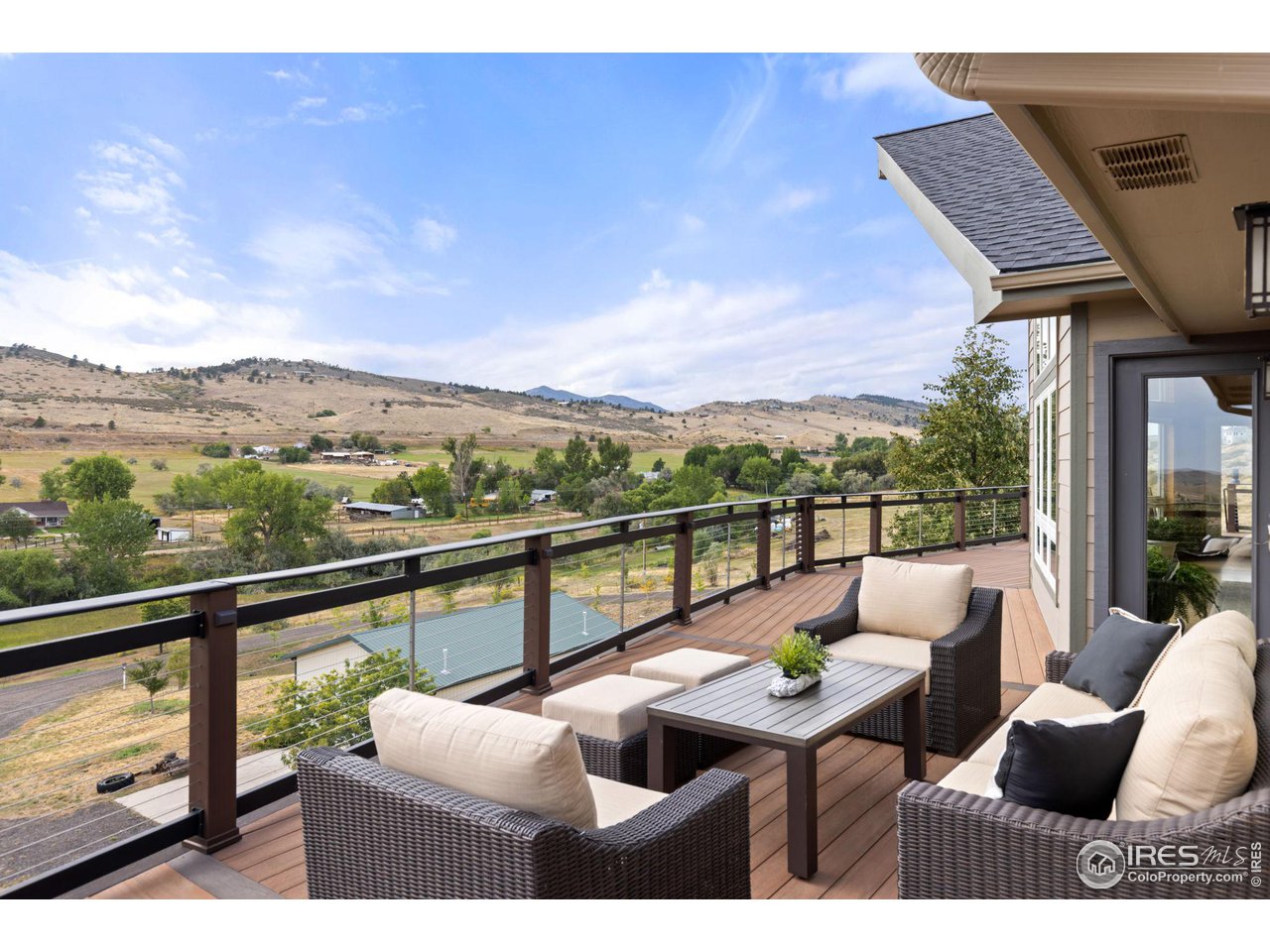 6586 Abaco Lane Berthoud, CO 80513 - Photo 4 of 40 a view of a city from a balcony with furniture