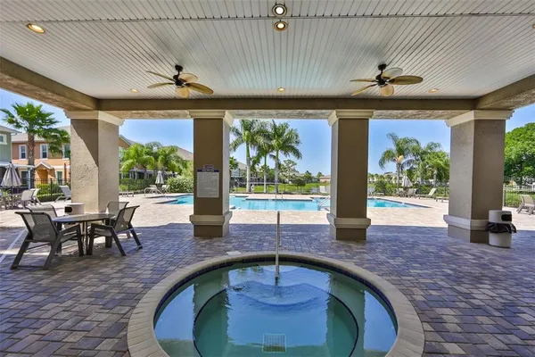 a swimming pool with outdoor seating