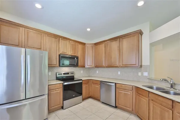 a kitchen with a refrigerator sink and microwave