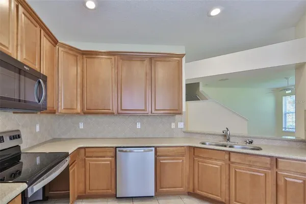 a kitchen with granite countertop a sink and cabinets