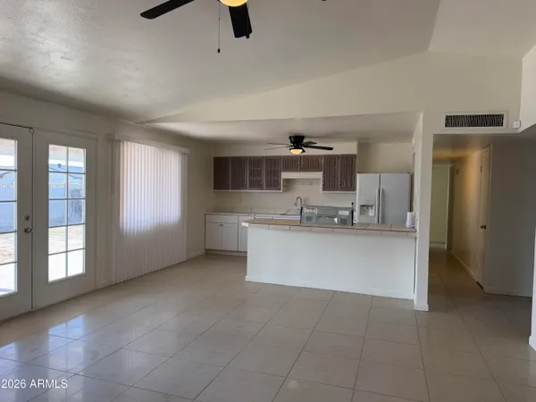 a view of kitchen with stainless steel appliances granite countertop a refrigerator and a sink