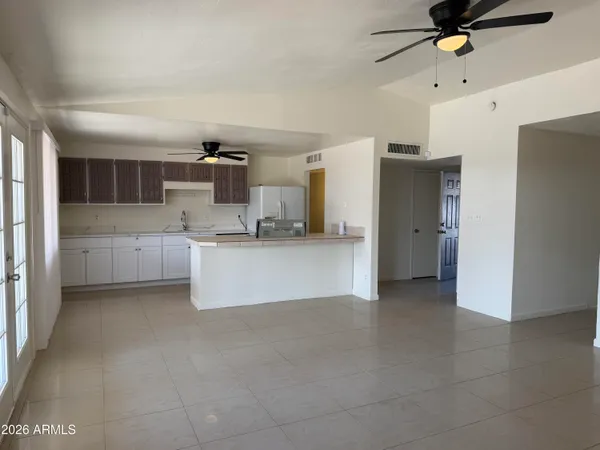 a view of kitchen and refrigerator