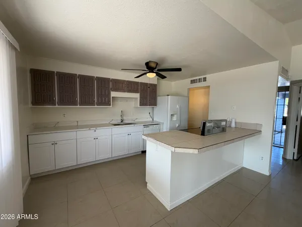 a kitchen with cabinets and window