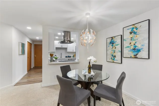 a view of a dining room with furniture and chandelier