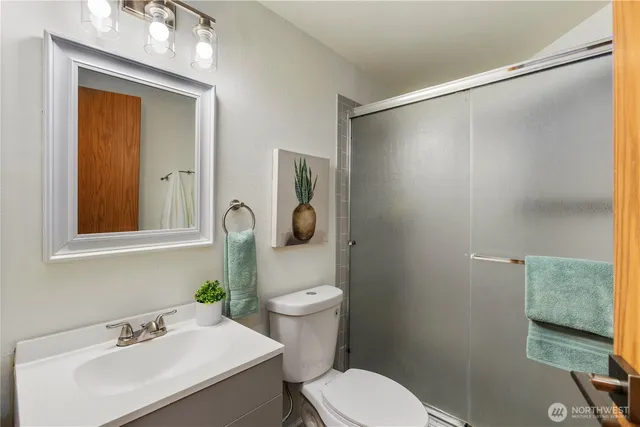 a bathroom with a sink a toilet and shower curtain