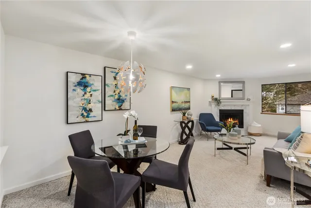 a living room with furniture a fireplace and a table