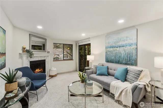 a living room with furniture a fireplace and a flat screen tv
