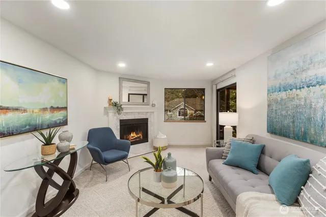 a living room with furniture a fireplace and a flat screen tv