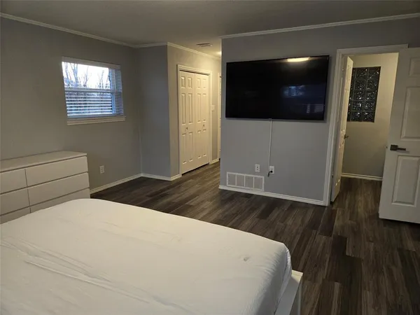 a bed room with a bed and a television