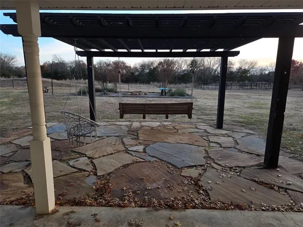 a view of a bench and wooden fence