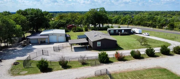 an aerial view of a house with a yard