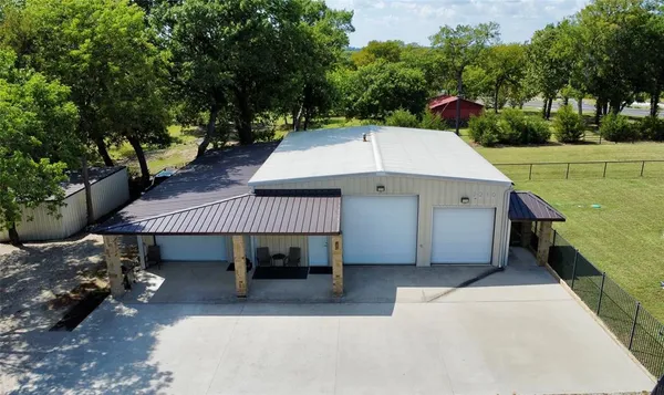 a view of a patio with a table and chairs under an umbrella