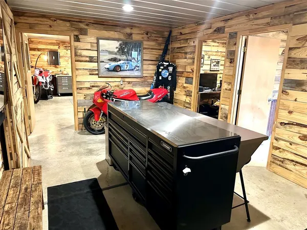 a utility room with stainless steel appliances kitchen island granite countertop a stove and a refrigerator