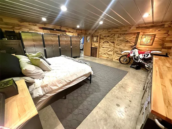 a bedroom with bed and a car parked