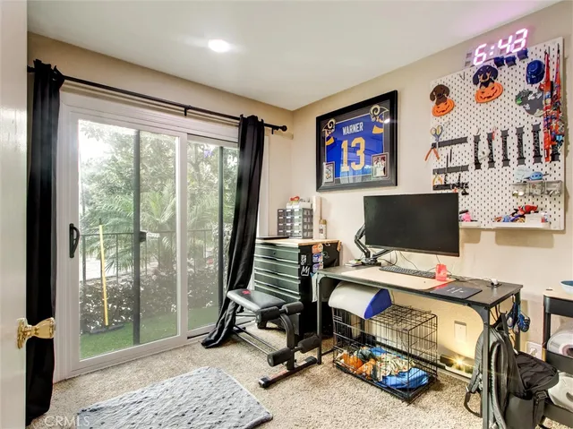 a view of a workspace with furniture and a flat screen tv