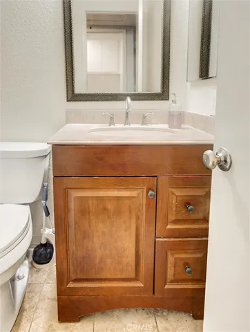 a bathroom with a sink a toilet and mirror
