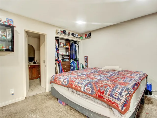 a bedroom with a bed and a book shelf