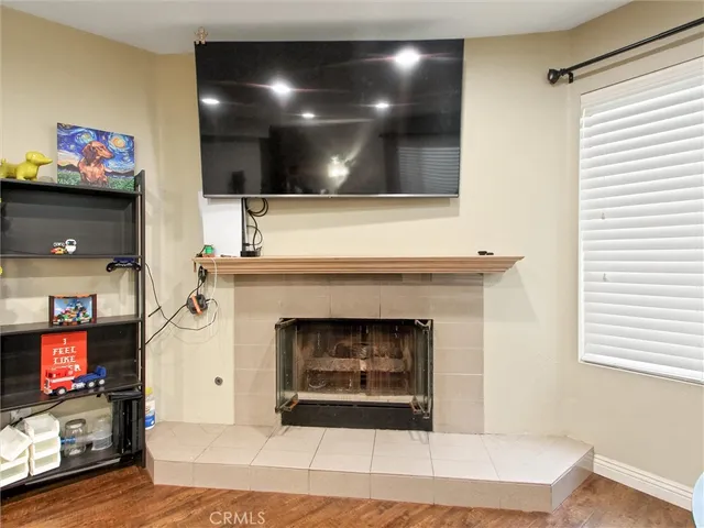 a living room with a fireplace and a flat screen tv
