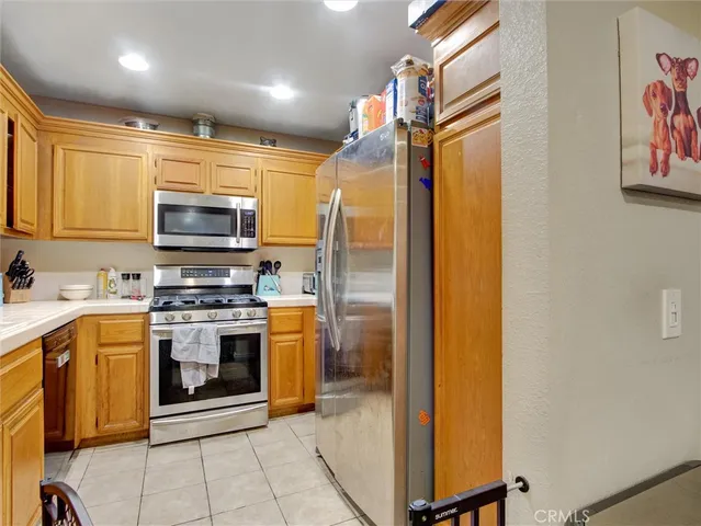 a kitchen with stainless steel appliances a stove microwave and refrigerator