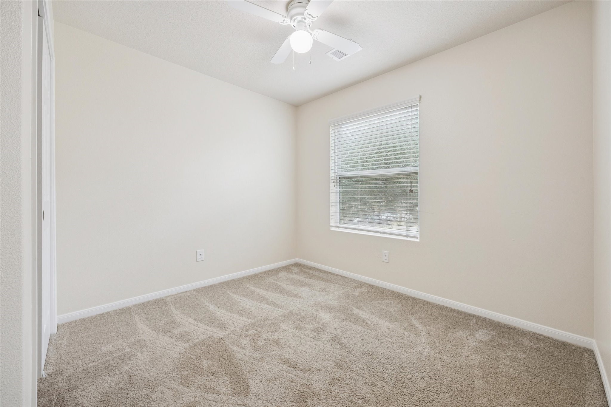 5003 Juniper Spring Trail Katy, TX 77449 - Photo 11 of 13 an empty room with a window and a fan
