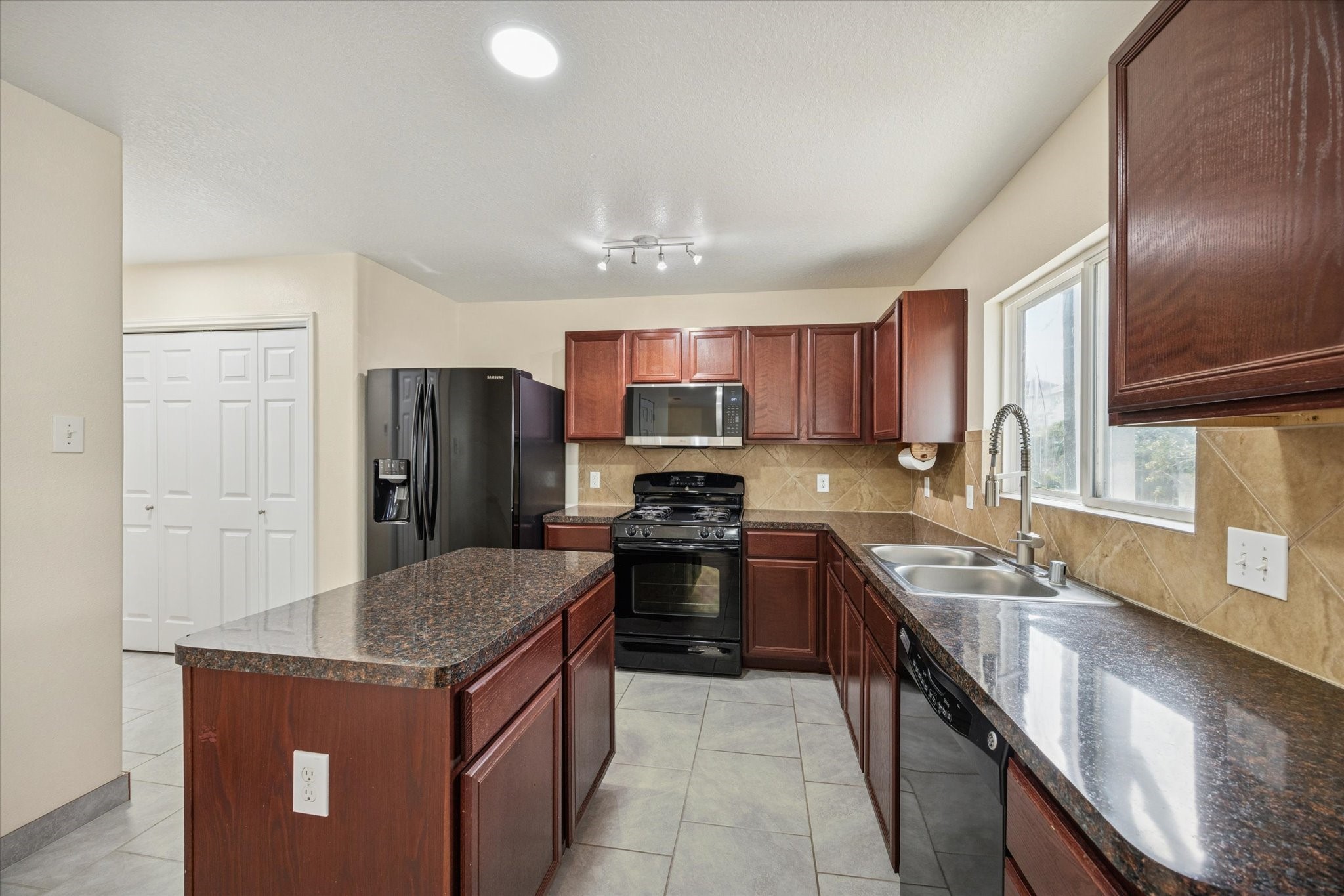 5003 Juniper Spring Trail Katy, TX 77449 - Photo 2 of 13 a kitchen with stainless steel appliances granite countertop a sink stove and refrigerator