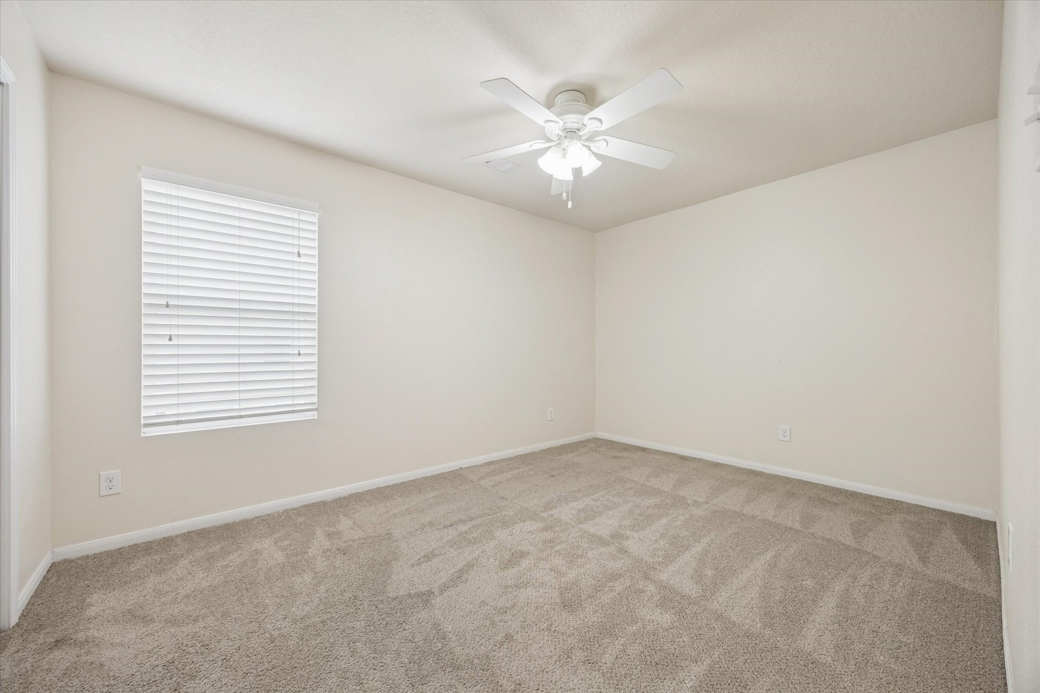 5003 Juniper Spring Trail Katy, TX 77449 - Photo 9 of 13 an empty room with windows and fan