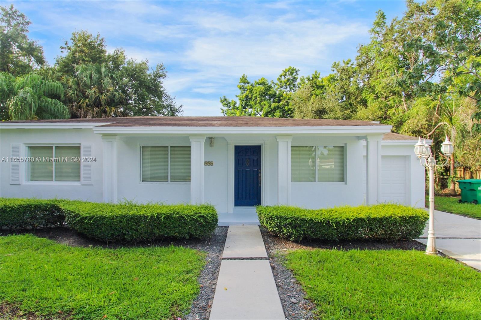 6990 Southwest 58th Street Miami, FL 33143 - Photo 2 of 11 front view of a house with a yard