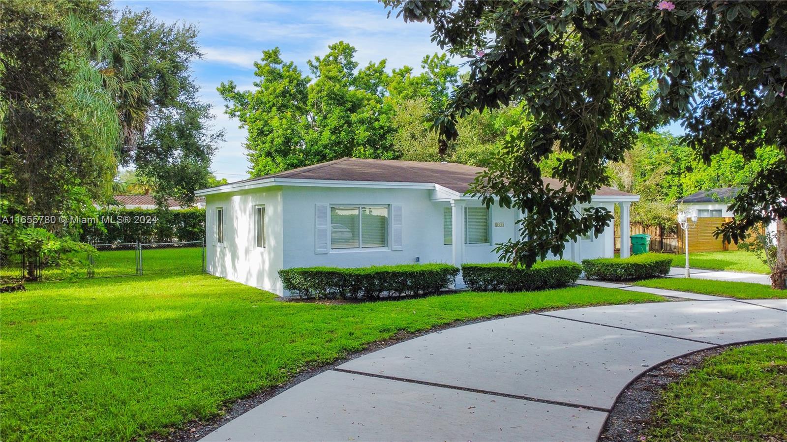 6990 Southwest 58th Street Miami, FL 33143 - Photo 3 of 11 a view of a house with a yard