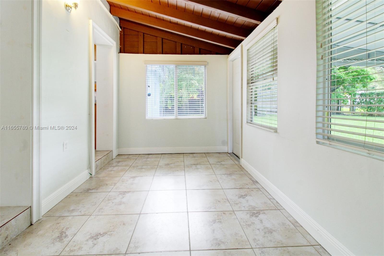 6990 Southwest 58th Street Miami, FL 33143 - Photo 7 of 11 an empty room with a window