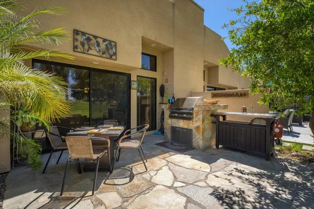 a view of a dinning tables and chairs in a patio
