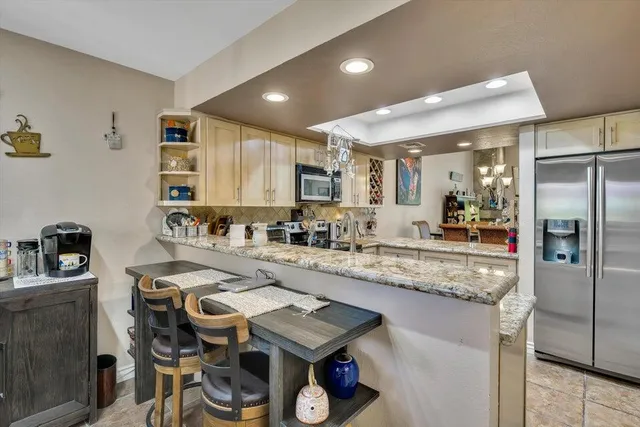 a kitchen with sink refrigerator and microwave