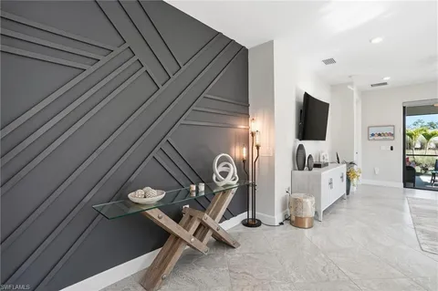 a view of a livingroom with furniture and a flat screen tv