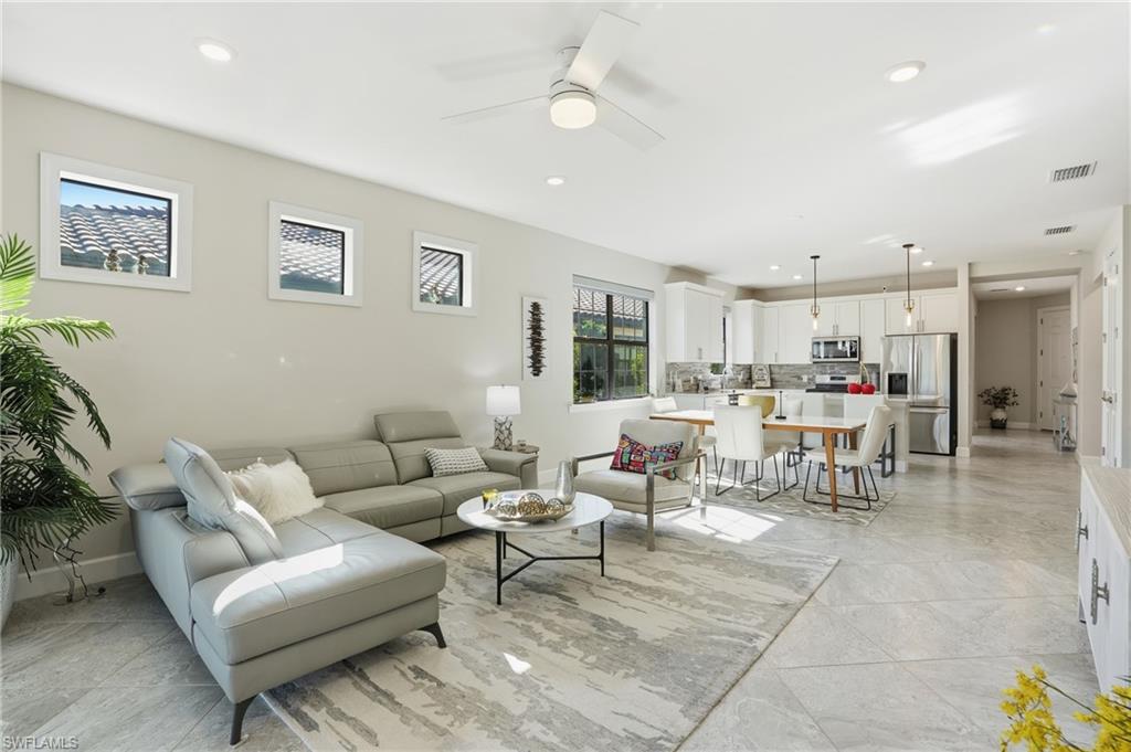 17377 Corsini Drive Fort Myers, FL 33913 - Photo 17 of 49 a living room with lots of furniture and a view of kitchen