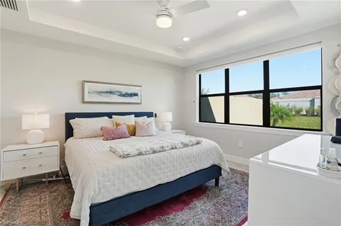 a bedroom with a large bed and a large window