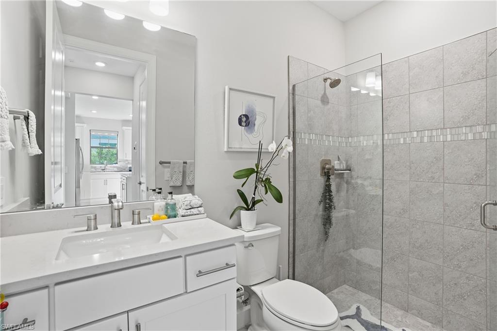 17377 Corsini Drive Fort Myers, FL 33913 - Photo 24 of 49 a bathroom with a sink toilet a mirror and shower