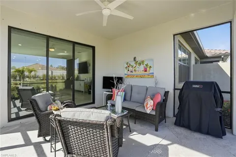 a living room with furniture and a floor to ceiling window