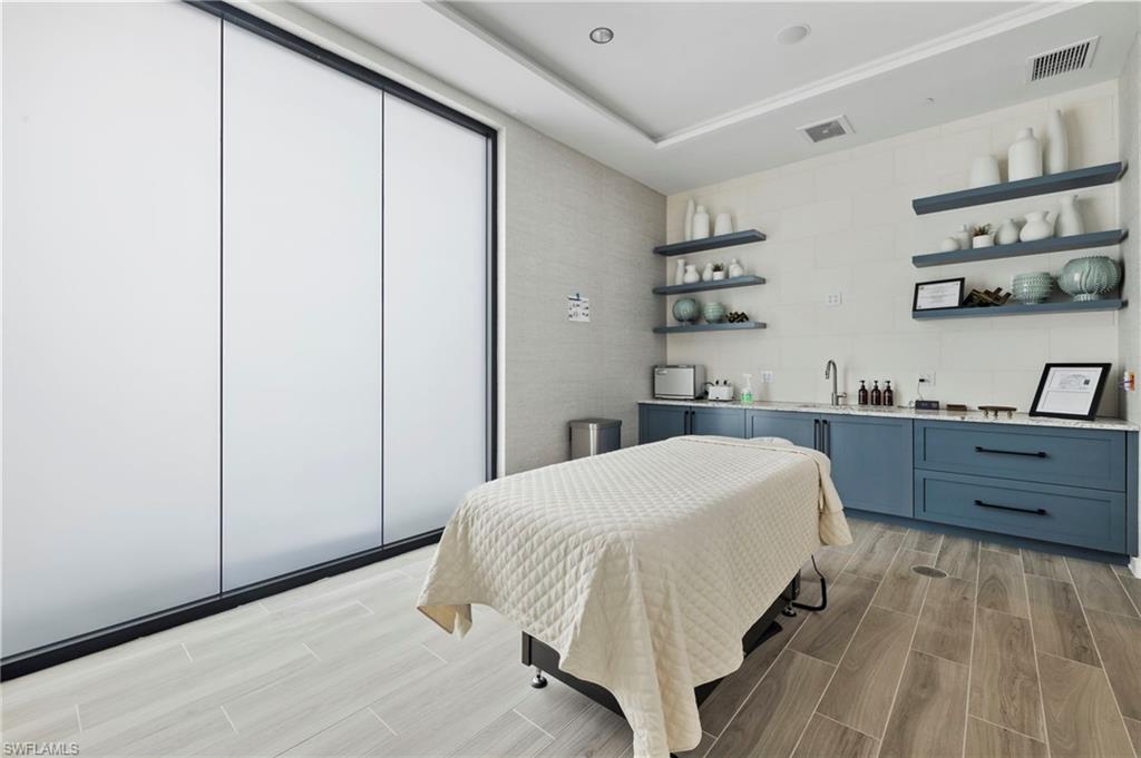 17377 Corsini Drive Fort Myers, FL 33913 - Photo 46 of 49 a bedroom with a bed and cabinets