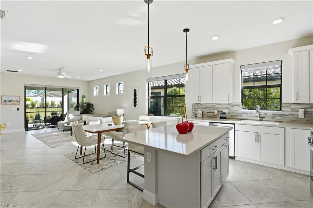 17377 Corsini Drive Fort Myers, FL 33913 - Photo 10 of 49 a kitchen with a sink stove and cabinets