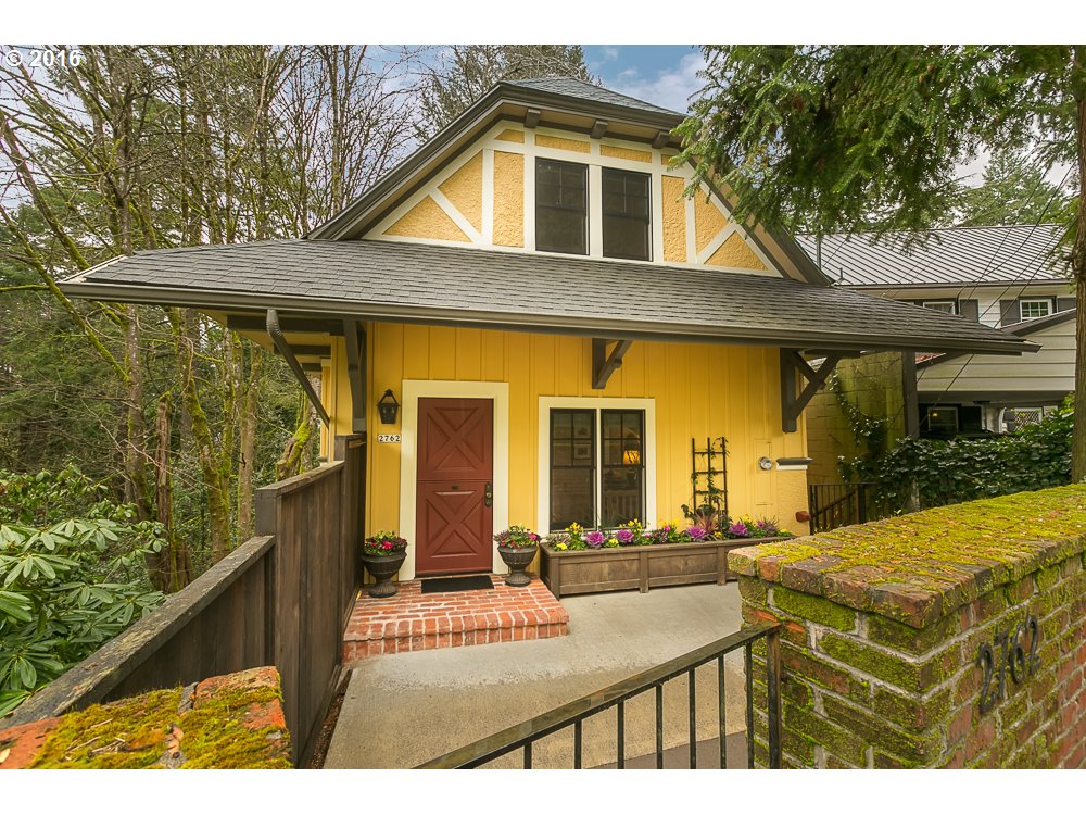 2762 Southwest Talbot Road Portland, OR 97201 - Photo 1 of 16 a view of a house with floor to ceiling windows and a dining table with chairs