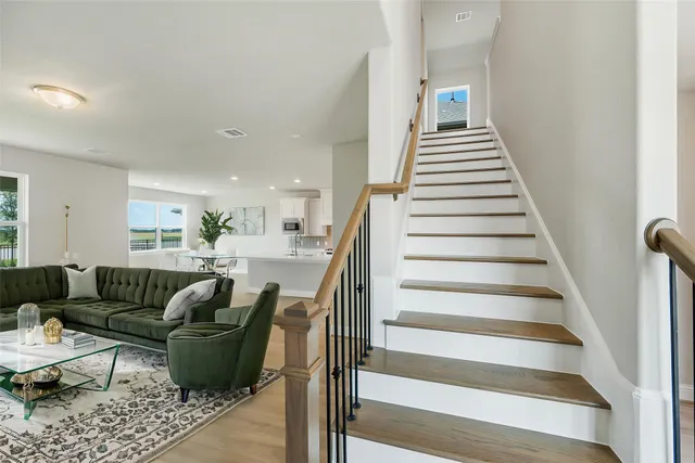 a living room with furniture and a stairs