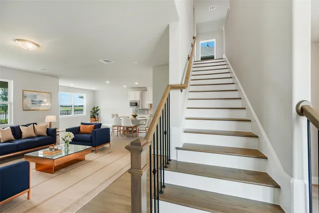 a living room with furniture and stairs