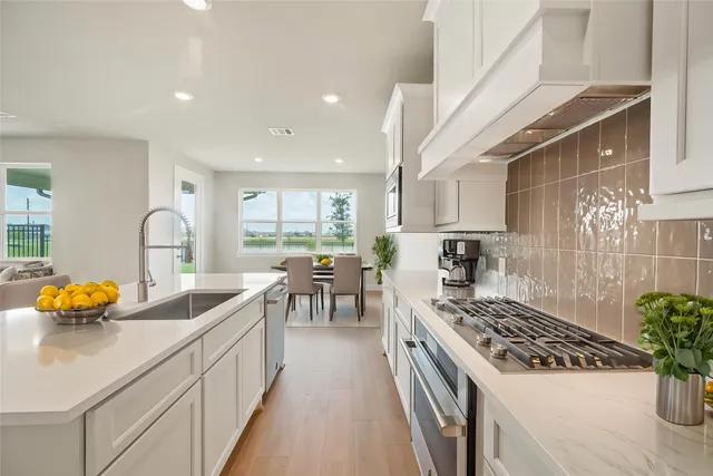 a kitchen with blue cabinets and appliances