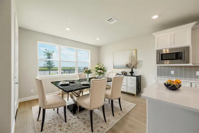 a dining room with furniture and window