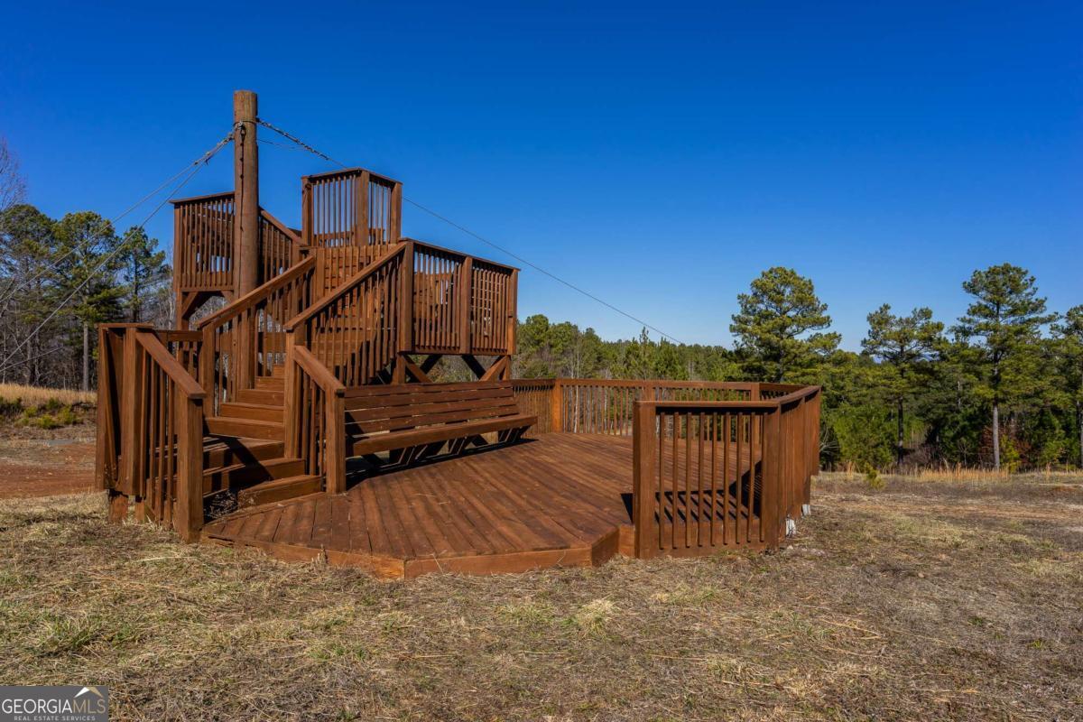 825 Young Loop Fairmount, GA 30139 - Photo 27 of 32 a view of a house with wooden fence roof deck and furniture