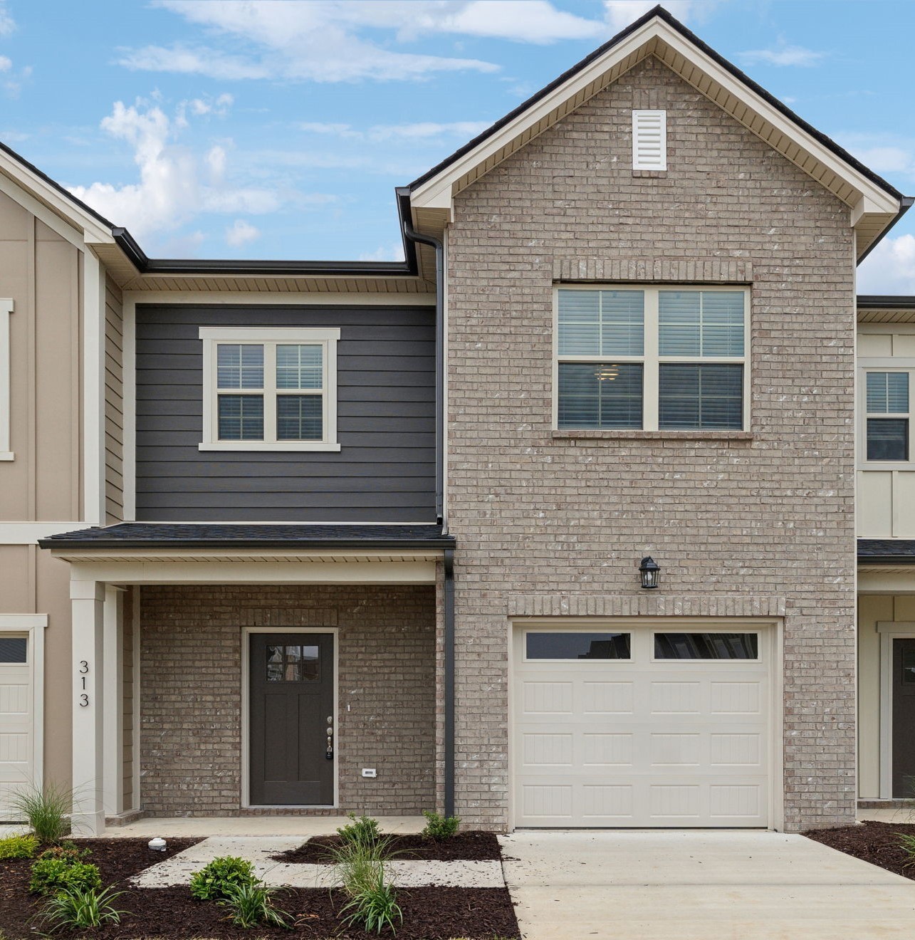 a front view of a house with garage