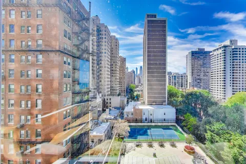 a kitchen with stainless steel appliances granite countertop a sink and a refrigerator