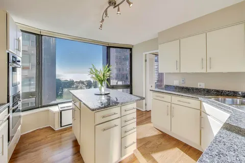 a kitchen with counter top space cabinets and appliances